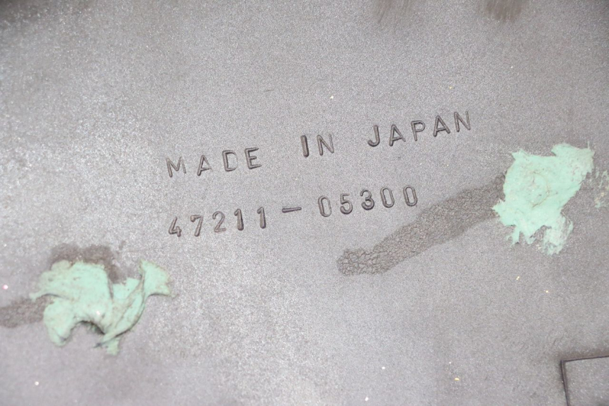 photo de TAPA BAJO ASIENTO IZQUIERDA SUZUKI GN 125 (1997 - 2000) - Detalle de la pieza